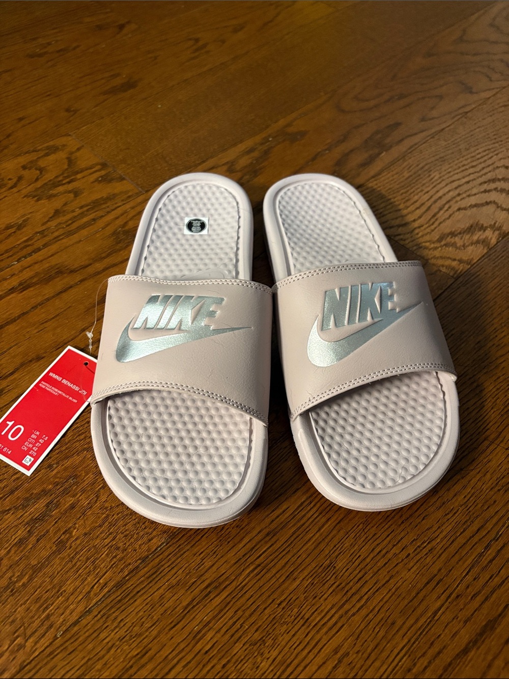 Nike women’s Light Pink Slide Sandals with Metallic Logo